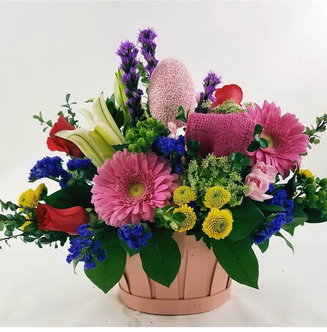 A photo of a bouqet with pink, blue, and red flowers