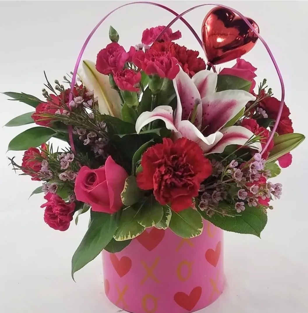 A photo of a Valentine's themed bouquet with red and pink flowers