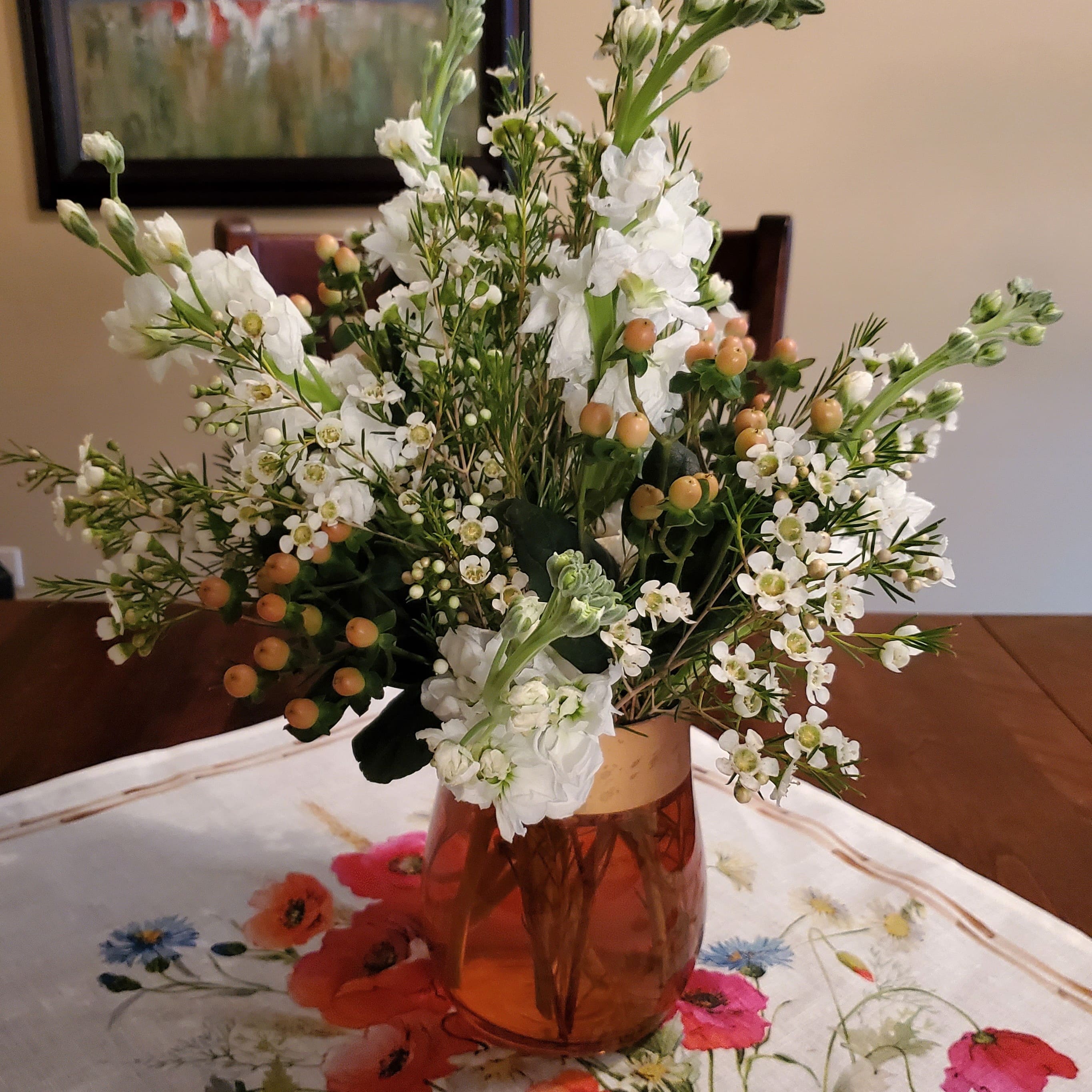 A photo of a bouquet with white flowers and green stems