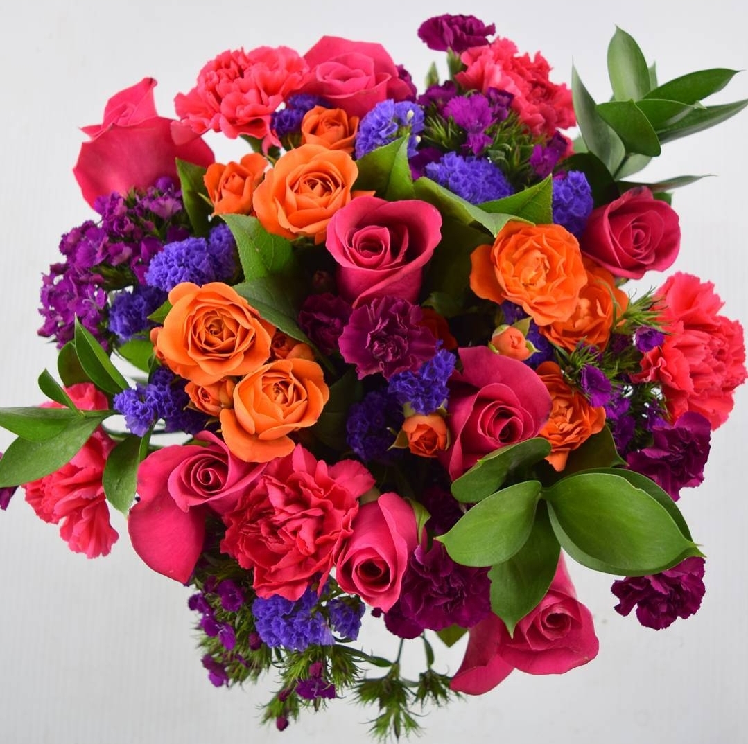 A photo of a bouqet with orange, pink, and purple flowers