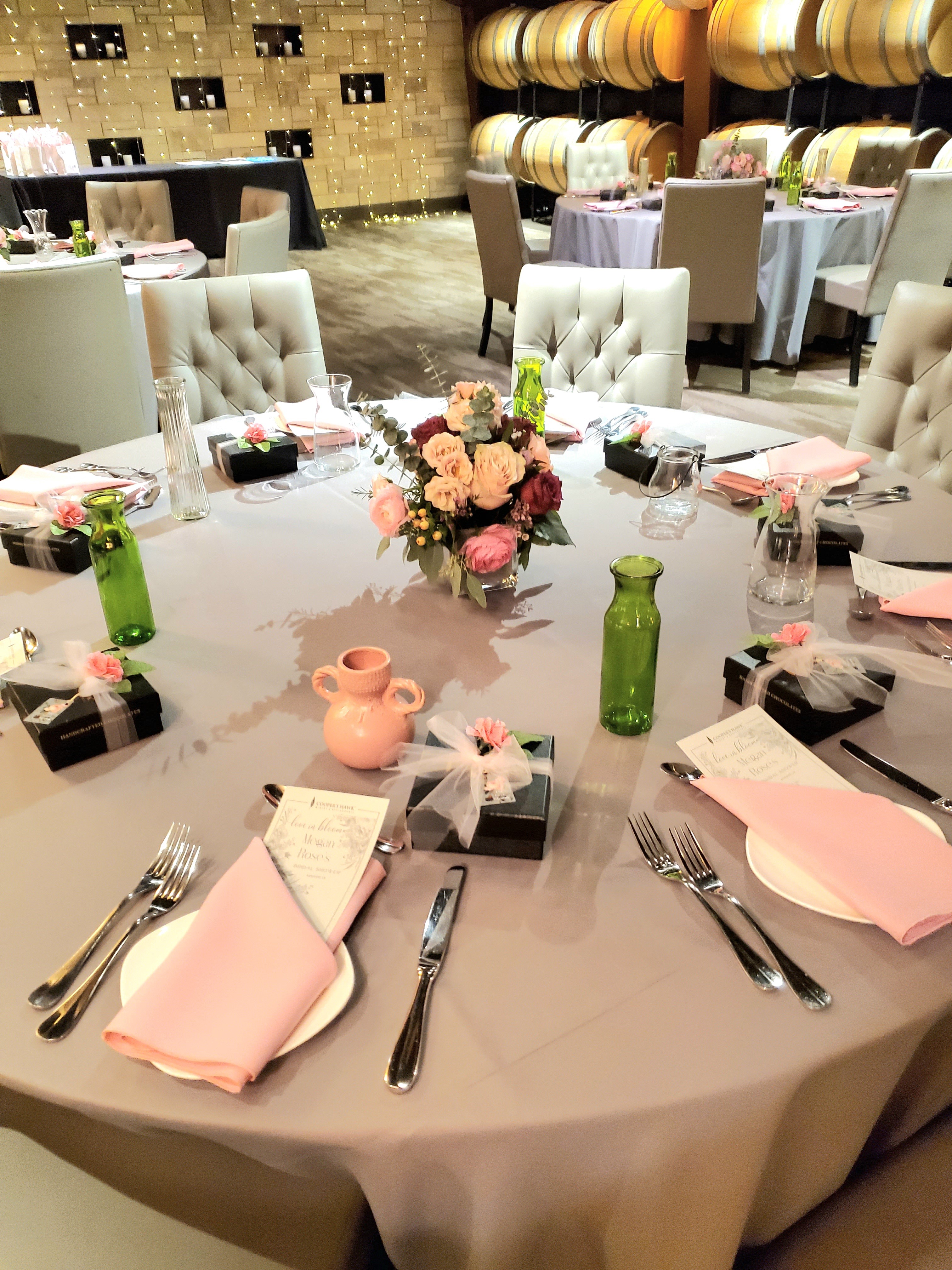 A beautiful centerpiece on a wedding table with plates and silverware